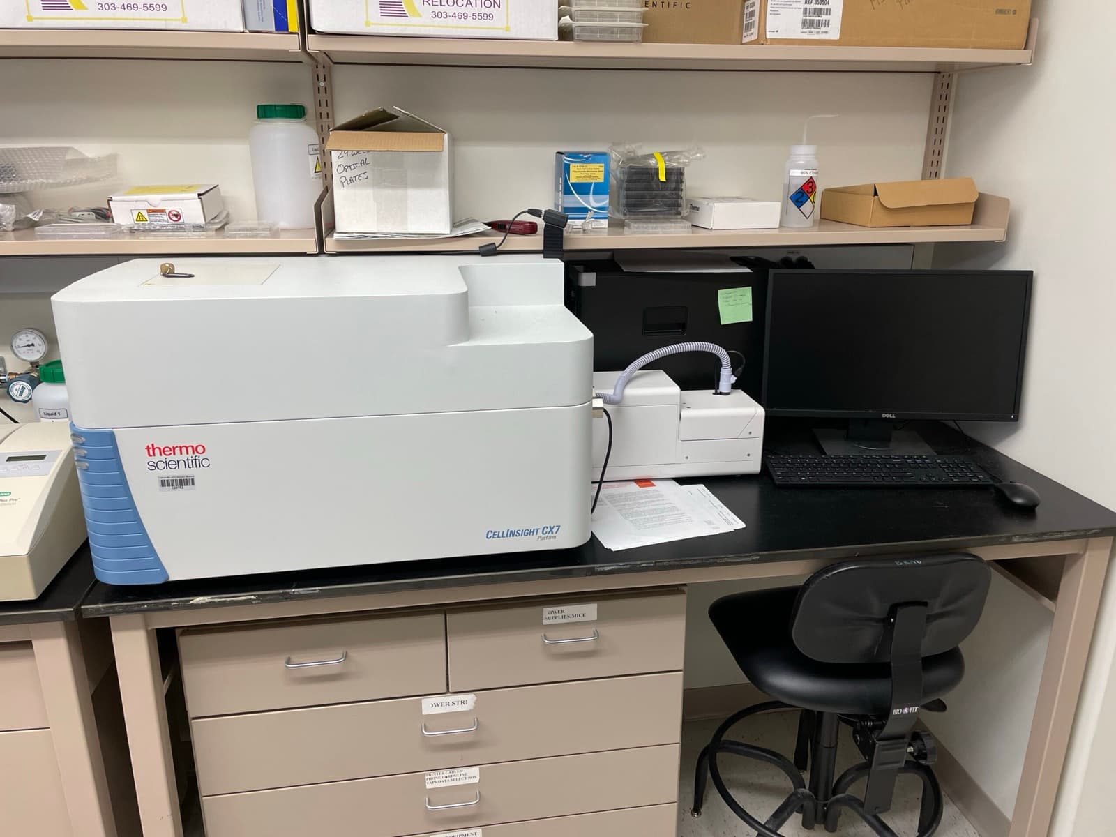 A high-content screening instrument on a lab bench